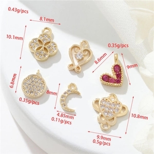 Detail of 14K gold filled charms with zirconia hearts and moons showing weight and size