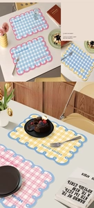 Close-up of waterproof PU leather placemat with checkered pattern and wavy edges