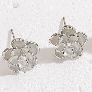 Close-up of S925 silver camellia flower earrings with zircon and white enamel