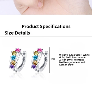 Detail view of 17mm round hoop earrings featuring multi-color zircon stones and gold plating