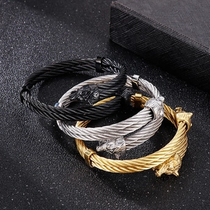 Detail of wolf head braided wire bracelets in gold, silver, and black finishes