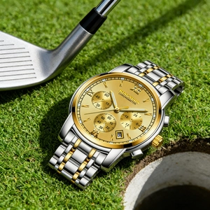 Luxury men's stainless steel watch with gold dial shown on a professional golf green