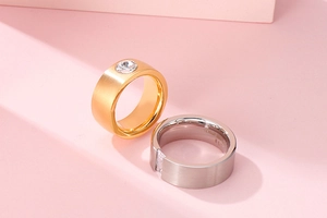 Macro shot of gold and silver stainless steel rings with clear round cubic zirconia