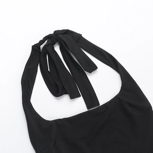 Detail of halter neck tie and knitted fabric texture on black slim fit jumpsuit