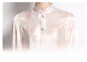 Detailed view of mandarin collar and floral satin fabric with crystal buttons on the dress