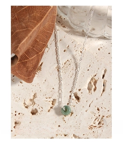 Detailed view of S925 sterling silver necklace featuring a green jade donut pendant