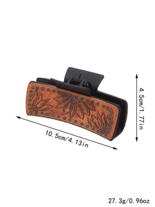 Detail of faux leather hair claw clip showing sunflower pattern and 10.5cm size markings