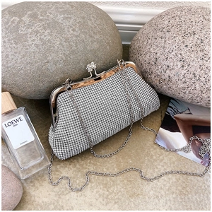 Detail of silver rhinestone evening clutch with crystal inlay and delicate chain strap