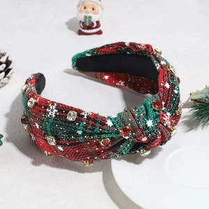 Detailed view of festive red and green plaid headband with rhinestones and snowflakes
