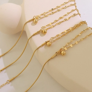 Double-layered gold chain bracelet with polished round beads and snake chain texture