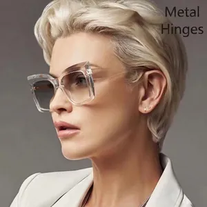 Chic cat-eye sunglasses with transparent large frames and grey gradient lenses on a model