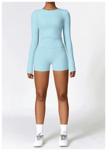 Front view of light blue long-sleeve yoga top and high-waist fitness shorts set