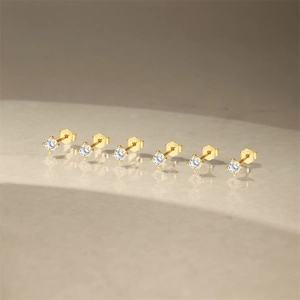 Close-up of S925 hallmark on gold plated sterling silver four-claw stud earrings