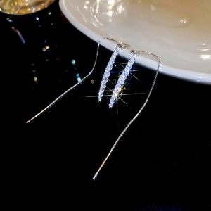 Detailed view of silver long chain tassel earrings with sparkling white cubic zirconia
