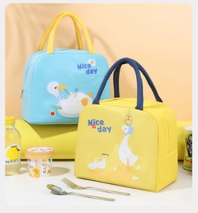 Detailed view of insulated lunch bags with cute cartoon goose designs in blue and yellow