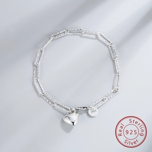Close-up of S925 sterling silver heart bracelet with paperclip chain and hammered texture