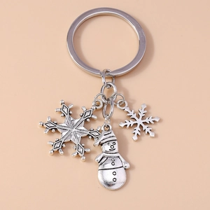 Detail of silver Christmas keychain with snowman and snowflake metal pendants