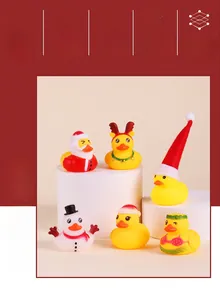 Close-up of Christmas rubber ducks in Santa and reindeer costumes on white pedestals