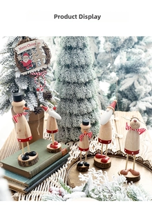 Detailed view of handcrafted wooden Christmas figures on a tray with festive decor