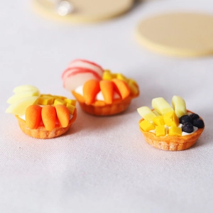 Dollhouse miniature fruit tarts with blueberry and mango toppings for OB1 dioramas