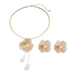 Metallic ginkgo flower necklace with faux pearl tassels and dimensional floral details