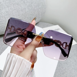 Fashionable rimless oversized sunglasses with purple gradient lenses and metal accents