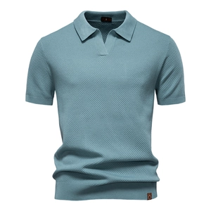 Detailed view of the light blue knit polo shirt with waffle texture and v-neckline