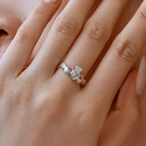 Macro detail of a silver S925 Claddagh ring with a sparkling heart diamond and crown design