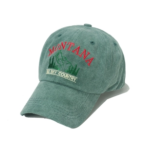 Vintage green washed cotton baseball cap with Montana mountain embroidery 45-degree view