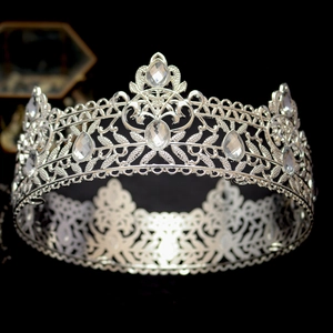 Close-up of luxury silver crown with water drop crystals and intricate hollow metal carving