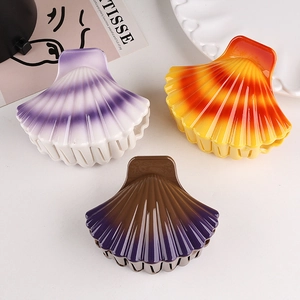 Detail of shell-shaped hair clips in gradient colors with fine comb teeth structure