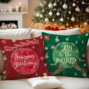 Detail of Christmas reindeer pillow covers on sofa with festive holiday decorations