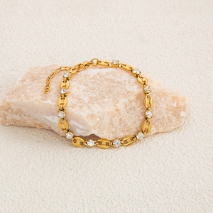Detailed view of 18K gold-plated evil eye bracelet with clear zircons on raw stone