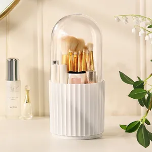 Rotating makeup brush holder with clear dustproof lid and white ribbed textured base