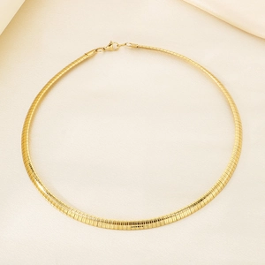 Close-up of golden omega chain collar with smooth finish and secure lobster clasp