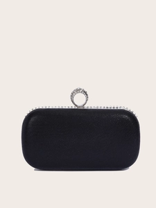 Detail of elegant black evening clutch with sparkling silver rhinestone ring fastener