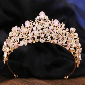 Detailed view of floral bridal tiara with pink crystals and clear rhinestones on velvet