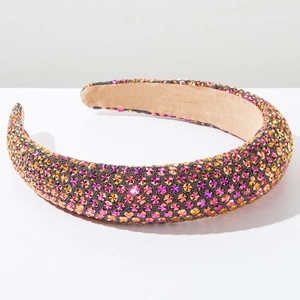 Detail view of thickened rhinestone headband showing colorful crystals and velvet lining