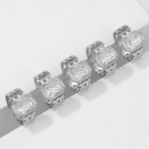 Detailed macro view of silver steel rings featuring embossed letters and chain texture