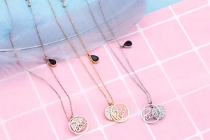 Macro shot of Peace letter pendant with rhinestones in rose gold, gold and silver