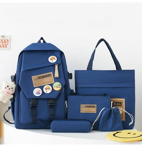 Blue 5-piece school backpack set featuring nylon bag with plush bear and badges