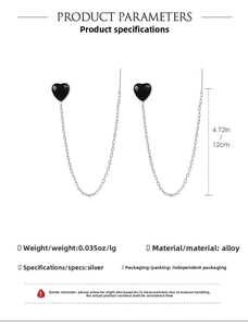 Detail showing 12cm long chain earrings with black heart charms and silver plating
