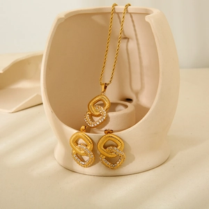 Golden double layer square pendant necklace and earrings set with zircons on ceramic tray