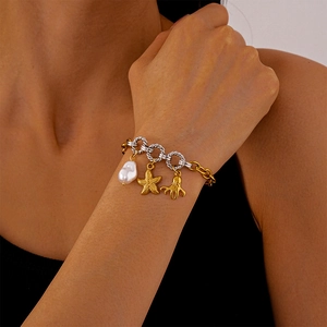 Detail showing gold octopus and starfish charms with white pearls on a mixed metal chain