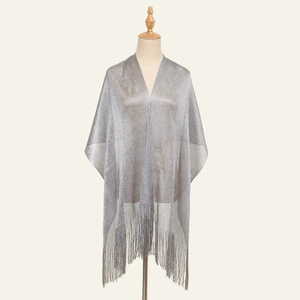 Detail of silver metallic shawl featuring long fringe tassels and shimmering lurex fabric