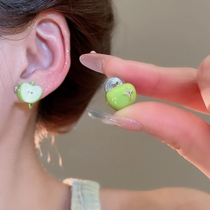 Close-up of green enamel apple stud earrings on model with zircon and silver needles