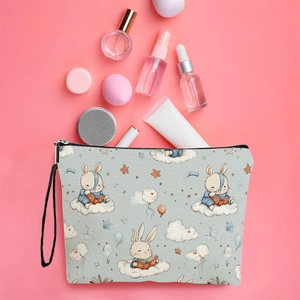 Blue canvas makeup bag with cartoon rabbit and clouds pattern on pink background