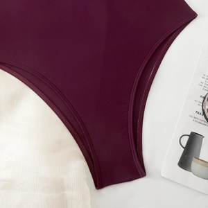 Detail of burgundy slimming bodysuit showing high-quality stitching and smooth fabric texture
