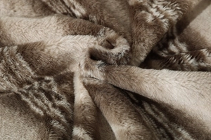 Detail of premium faux fox fur lining texture with soft brown and beige gradient plush