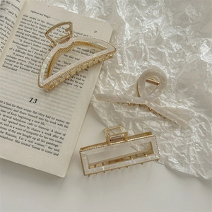 Three-piece set of gold French hair claws with pearlescent marble texture acetate finish
